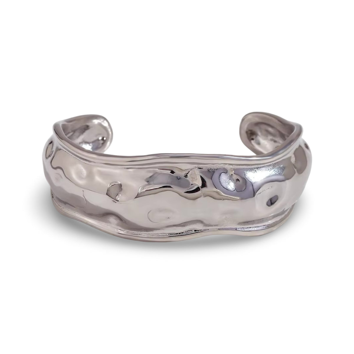 A polished silver cuff bracelet with a hammered, organic textured surface.